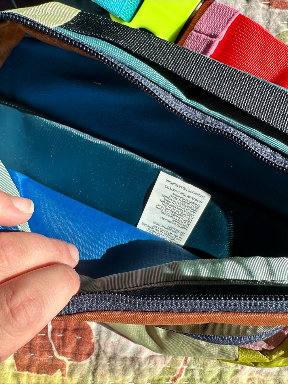 Cotopaxi colorful waist pack with teal, neon yellow, red and blue accents - Picture 2 of 3